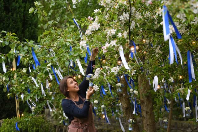 Lynne Hodgkinson, from in West Yorkshire, has been cheering up residents in her village and hopes to raise money to support the NHS with her special tree design after being inspired by the fundraising exploits of Captain Tom Moore. Photo credit: Jonathan Gawthorpe/ JPIMedia Resell