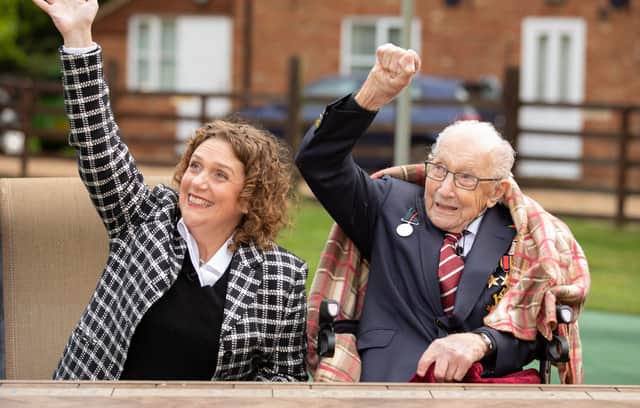Colonel Tom Moore and his daughter Hannah acknowledge the Battle of Britain flypast on the war veteran's 100th birthday.