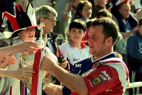Paul Broadbent captain of Sheffield Eagles takes the Challenge Cup to the Eagles supporters following the game against Wigan.