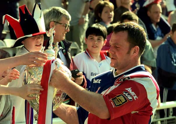 Paul Broadbent captain of Sheffield Eagles takes the Challenge Cup to the Eagles supporters following the game against Wigan.