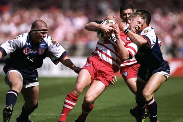 Denis Betts of Wigan Warriors is stopped by a high tackle from Dave Watson of Sheffield Eagles and darren Shaw, left, during the Silk Cut Challenge Cup final at Wembley Stadium in London. Sheffield won the match 17-8. (Picture:: Mike  Hewitt/Allsport)