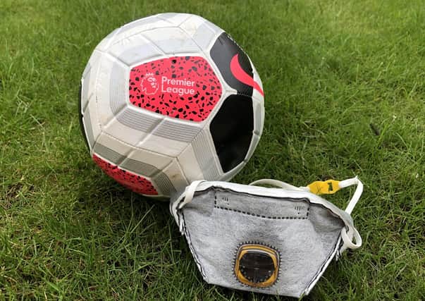 A Premier League Football along side a PPE face mask.