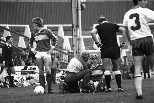 Middlesbrough FC physio Tommy Johnson administers the 'magic sponge' to winger Stuart Ripley during a match at Ayresome Park back in the 1990s.