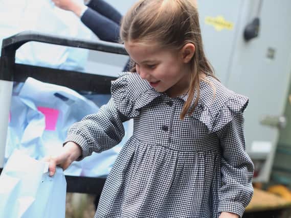 Princess Charlotte helping the Duke and Duchess of Cambridge pack and deliver food packages for isolated pensioners in the area around the Sandringham Estate in Norfolk. Photo credit: The Duchess of Cambridge/PA Wire