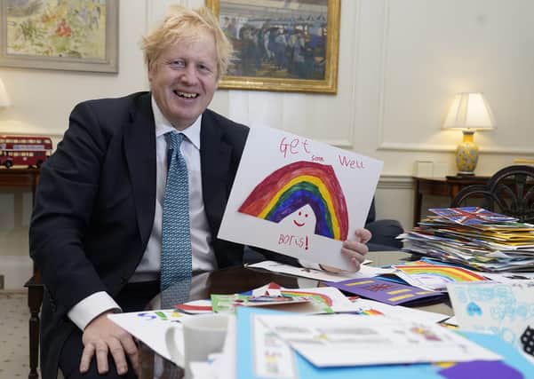 Boris Johnson with some of the get well cards that he received after being struck down with Covid-19.