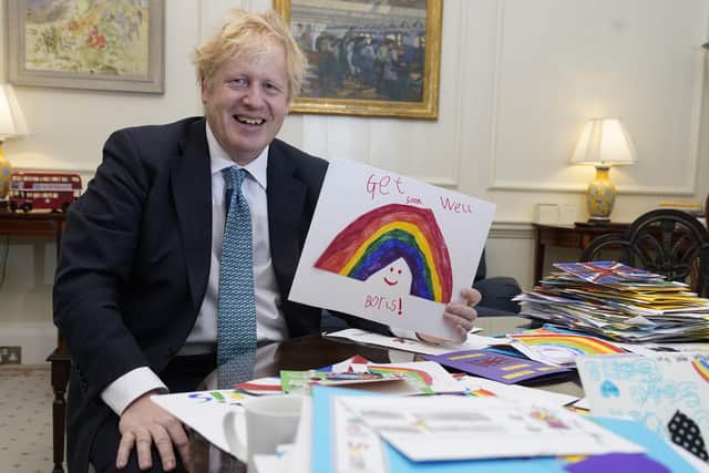 Boris Johnson with some of the many getwell cards sent to the Prime Minister.