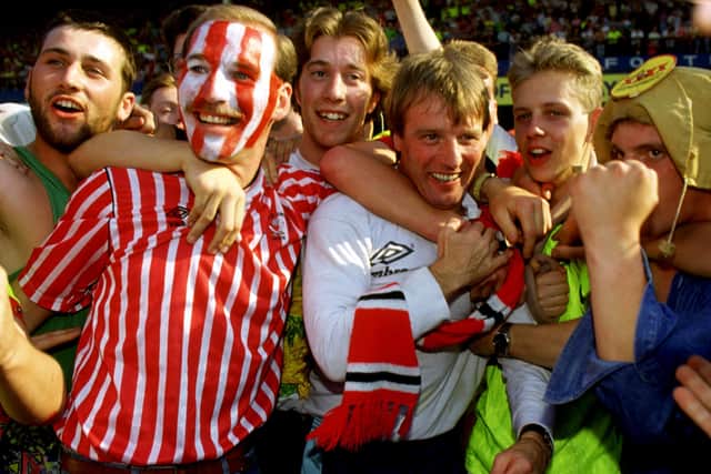 Mobbed: Blades manager 
Dave Bassett with the fans after winning promotion
with victory at Leicester City.