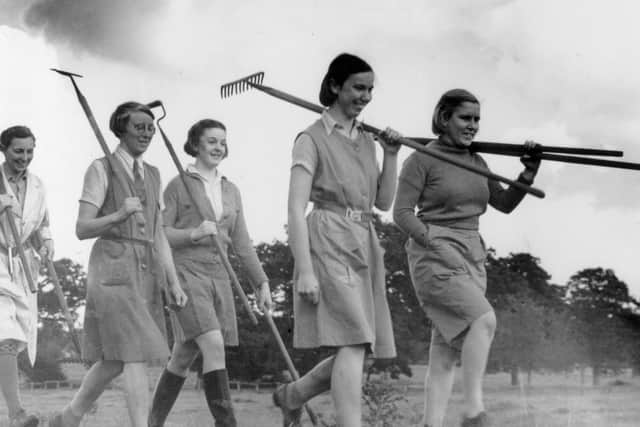 Young members of the Women's Land Army set out for a day's work on a farm in 1939. Photo by Nick Yapp/Fox Photos/Getty Images