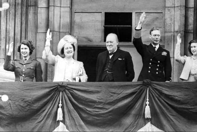 Winston Churchill joins the Princess Elizabeth, Queen Elizabeth, King George VI, and Princess Margaret, on the balcony of Buckingham Palace, London, England, on VE Day.