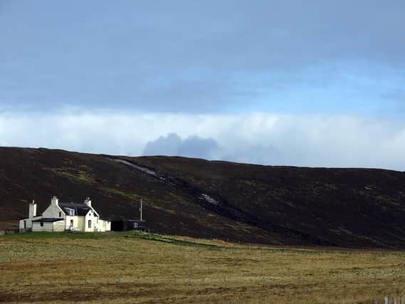 A lone farmhouse perched by the hills in the Shetlands. Photo: ANDY BUCHANAN/AFP via Getty Images