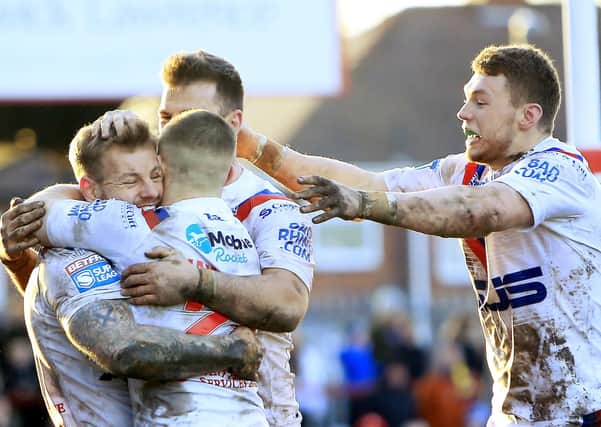BRING IT BACK: Wakefield Trinity's players celebrate Tom Johnstone's try against Warrington earlier this year. Picture: Chris Mangnall/SWpix.com