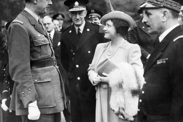 Queen Elizabeth of England (R) chats 27 October 1941 in London with French General Charles de Gaulle, the commandant of the "Free French" forces. It was in the summer of 1940, during the London blitz, that Queen Elizabeth won the respect and affection of her subjects when she refused to leave for Canada with her daughters as German bombs devastating the British capital. (Photo credit should read -/AFP via Getty Images)