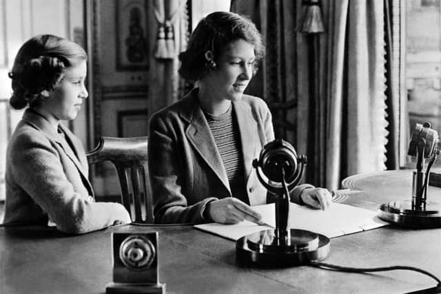 Picture taken October 1940 in Windsor shows the Britain's Princess Elizabeth (future Queen Elizabeth II) and her sister Princess Margaret sending a message during the BBC's children programme, particularly to the children who were being evacuated because of the World War II. (Photo by - / POOL / AFP)        (Photo credit should read -/AFP via Getty Images)