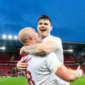 Fingers crossed: John Bateman, celebrating with Chris Hill England's victory over New Zealand in 2018, wants the Ashes to be played.