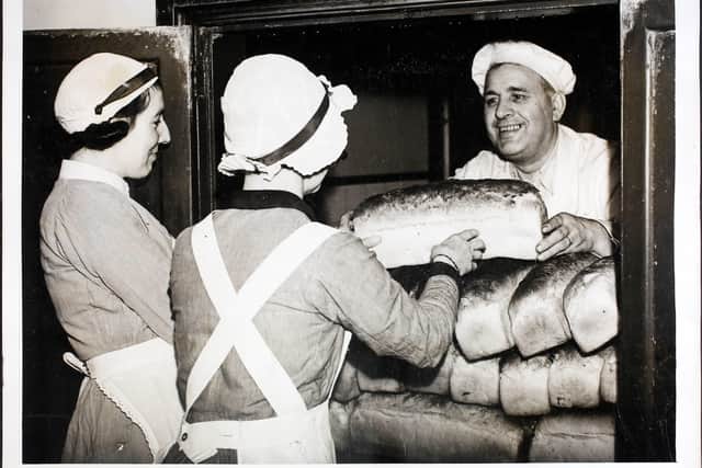 Mr Herbert Franks, the baker at Guy's Hospital in London, handing out loaves of bread to nurses at the hospital, London, England. Guy's is the only London Hospital with its own bakehouse for baking its own bread. Mr Herbert Franks, the baker, has worked in Guy's bakehouse for twenty five years and every day produces a regular supply for hospital patients and staff. (Photo by William Vanderson/Fox Photos/Hulton Archive/Getty Images)