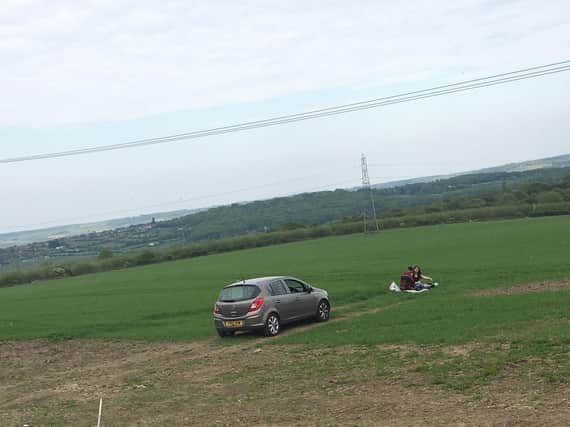 The young couple were pictured having a picnic in a field of spring barley