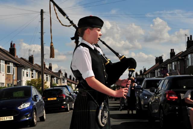 At VE Day celebrations on Beech Street in Harrogate, 14 year old Lucy Hall plays 
the bagpipes. Picture Gerard Binks