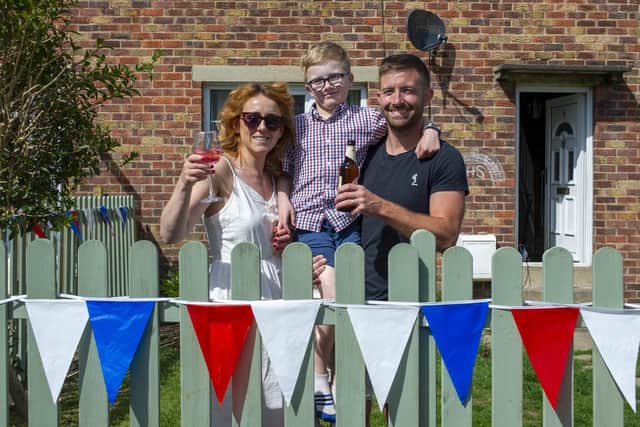 Amy and Andy Horsman with Leo raising a glass to celebrate the 75th anniversary of VE Day with a party on  Church Close. Picture Tony Johnson