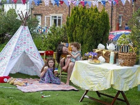 Michelle Adams with her children Penny and Joy celebrate the 75th anniversary of VE Day with a party on  Church Close, Pool in Wharfedale near Leeds. Picture Tony Johnson