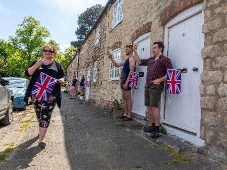 A number of residents in Old Malton came out of their homes at 3pm to raise a glass to the nation. Pictured resident Vicky Burgess with neighbours. Picture: James Hardisty
