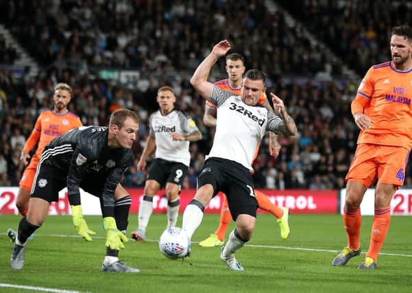 My ball: Cardiff City goalkeeper Alex Smithies collects the ball ahead of Derby County's Jack Marriott.