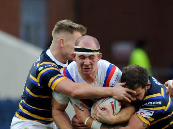 George King is tackled during Wakefield Trinity's Boxing Day derby at Leeds Rhinos. Picture by Steve Riding.