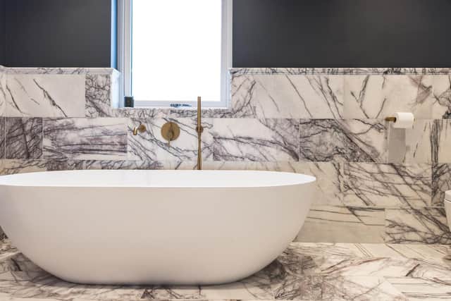 No expense has been spared on this bathroom, which features viola marble