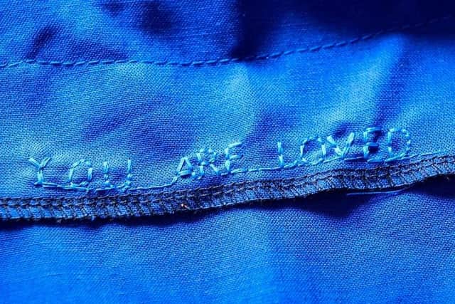 Jen Legg, a seamstress who is part of an online group sewing scrubs has shown her gratitude to frontline workers by including personal messages in some garments. Photo credit: Danny Lawson/PA