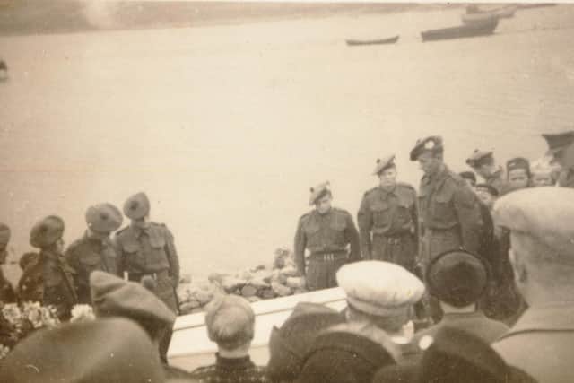 Soldiers stationed on the island were present at the funeral