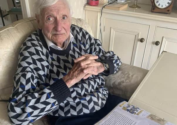 Mike Skipp, 95, with the memory book made by Tim Moran