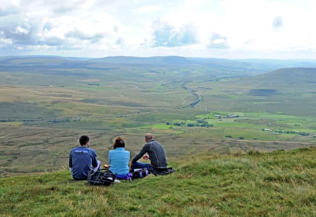 Walkers take a break and look down on Ribblehead from the summit of Whernside in 2019. Picture: Tony Johnson.