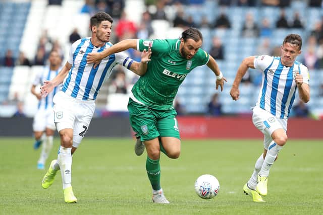 Huddersfield Town's Christopher Schindler, left, battles for the ball with Sheffield Wednesday's Atdhe Nuhiu at The John Smith's Stadium last September. Picture: Martin Rickett/PA.