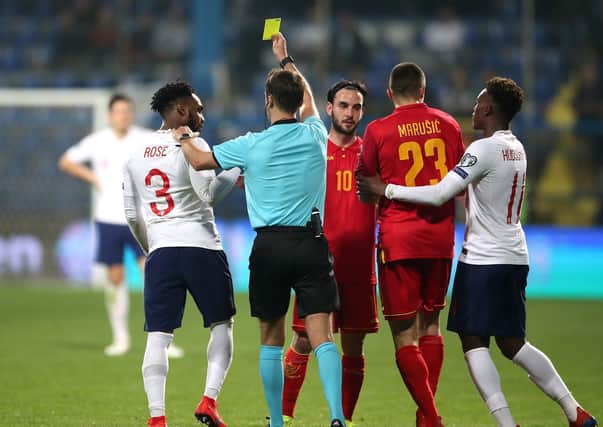 England's Danny Rose, far left, is shown a yellow card by referee Aleksei Kulbakov (centre) during the UEFA Euro 2020 Qualifying match in March 2019. Several England players, including Rose, were subjected to vile racist abuse by home fans. Picture: Nick Potts/PA