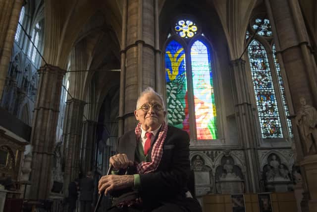 David Hockney poses in front of The Queen's Window, a new stained glass window designed by Hockney and created by Barley Studio York, at Westminster Abbey in central London on September 26, 2018. (Photo by Victoria Jones / POOL / AFP via Getty Images)