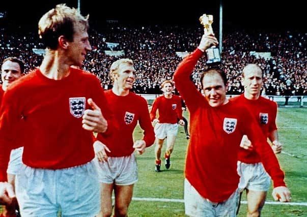 Ray Wilson with the Jules Rimet trophy flanked by the Charltons, Jack and Bobby, with George Cohen, Bobby Moore and Alan Ball behind