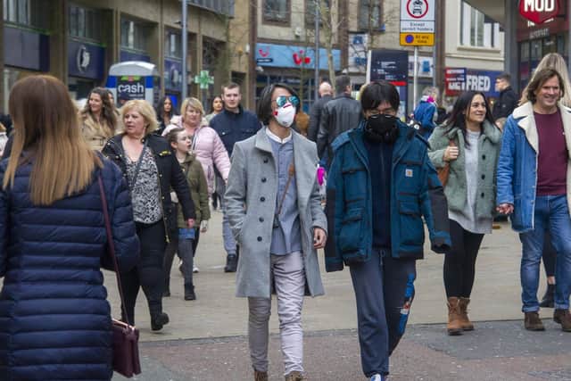 The new test can identify people who have had coronavirus even if they have never had any indication they are infected. Pictured: People on Leeds Briggate wearing face masks before the UK lockdown on march 23.