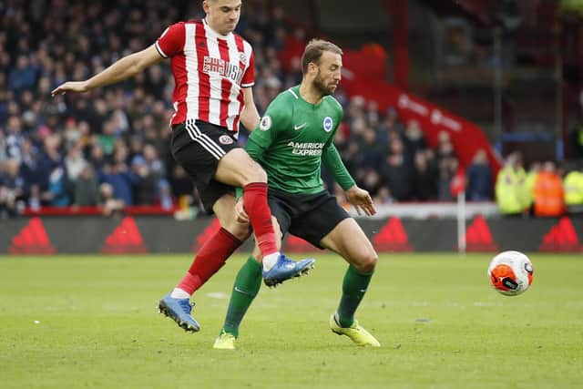 RESERVATIONS: Brighton and Hove Albion's Glenn Murray (right) has doubts about "project restart", despite the support of Sheffield United players such as John Egan (left)