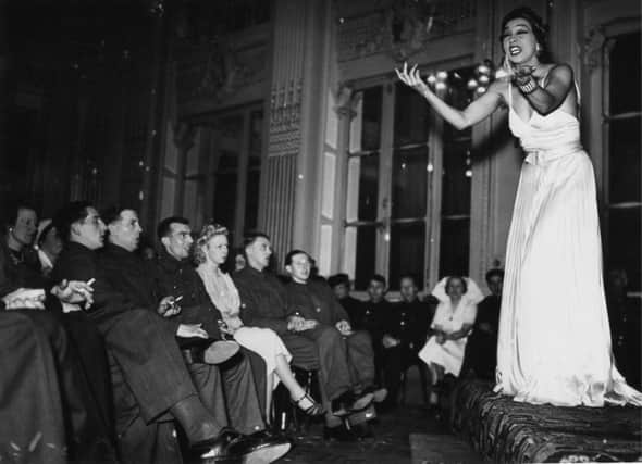 Josephine Baker performs for troops at the British Leave Club at the Hotel Moderne in Paris, May 1940. (Photo by Fox Photos/Hulton Archive/Getty Images)