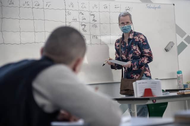 A teacher wearing a protective mask leads a class of tenth grade students at the Hannah Hoech community school on April 27, 2020 in Berlin, Germany.  (Photo by Till Rimmele/Getty Images)