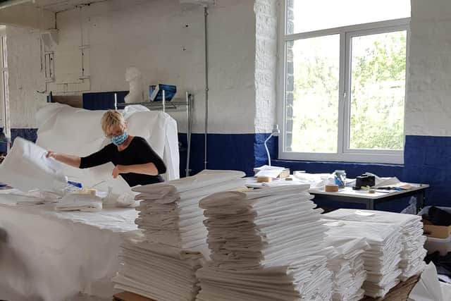 Volunteer Taru making PPE at the McNair shirts factory at Slaithwaite near Huddersfield.