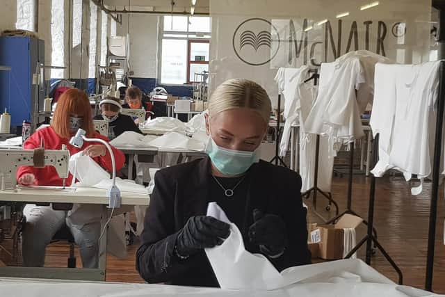 Volunteers Maddie, Ruth, Hannah and Susan making PPE at the McNair Shirts factory at Slaithwaite near Huddersfield.