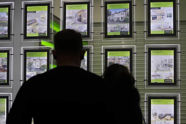 People looking at the signs in an estate agent's window in north London in 2016. Picture: Yui Mok/PA Wire