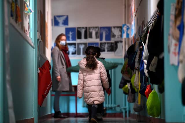 Children prepare to enter their classroom at the Saint Germain de Charonne school in Paris on May 14, 2020 as primary schools in France re-open this week and the country eases lockdown measures taken to curb the spread of the COVID-19 (the novel coronavirus). (Photo by FRANCK FIFE / AFP)