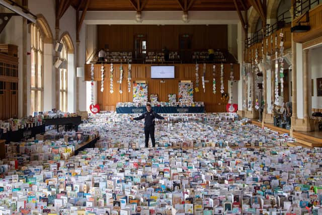 Captain Tom Moore's grandson Benjie, in the Great Hall of Bedford School, Bedfordshire, where over 120,000 birthday cards sent from around the world are being opened and displayed by staff. Picture: Joe Giddens/PA.