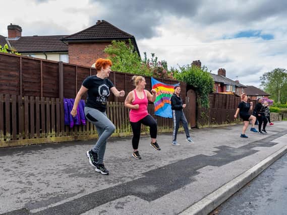 People in Kirkstall join an exercise class in the street to help boost their mental health and fitness.