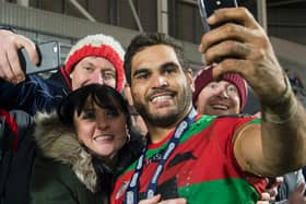South Sydney Rabbitohs's Greg Inglis takes pictures with St Helens fans after the World Club Series game between the sides at Langtree Park in 2015. (Allan McKenzie/SWpix.com)