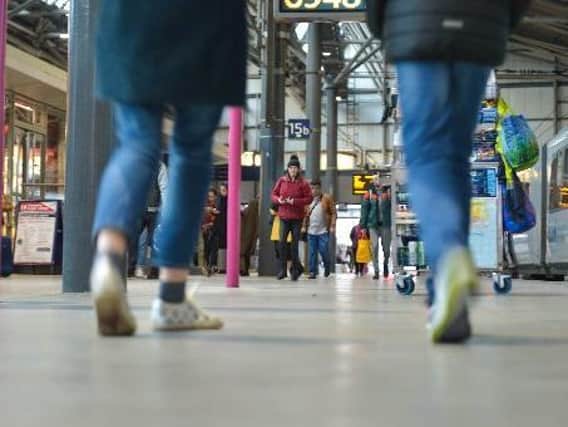 Pictured, passengers board trains at Leeds train station. Photo credit: SWNS