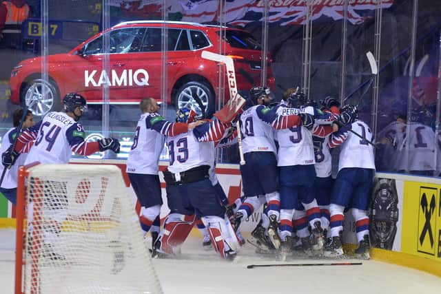 Ben Davies (hidden) is mobbed by his team-mates after scoring the overtime winner against France in Kosice. Picture: Dean Woolley.