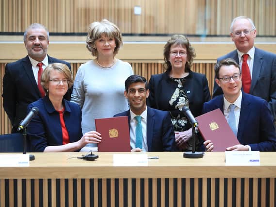 Local council leaders sign the proposed agreement, alongside Chancellor Rishi Sunak in March.