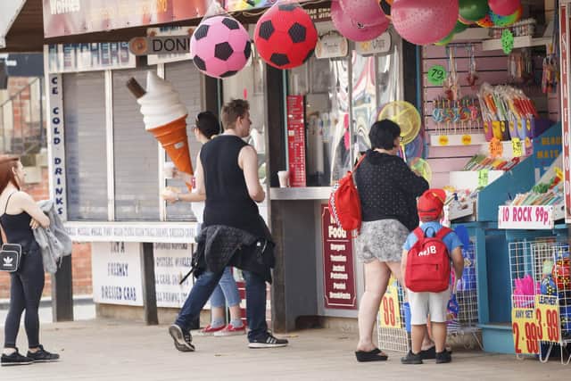 People social distance as they queue at a kiosk in Scarborough, as people head to parks and beaches with lockdown measures eased.